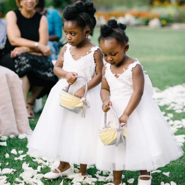 Inspiration - two flower girls walking down an aisle scattering flower petals from a basket