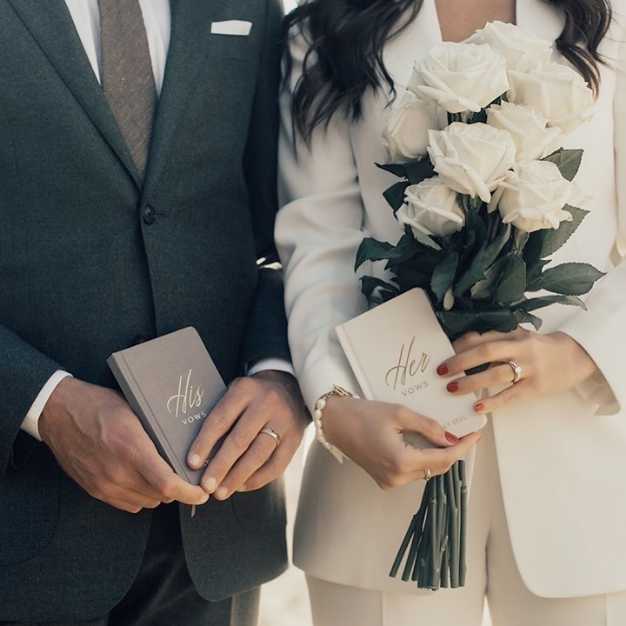 Inspiration - bride and groom each holding a vow journal
